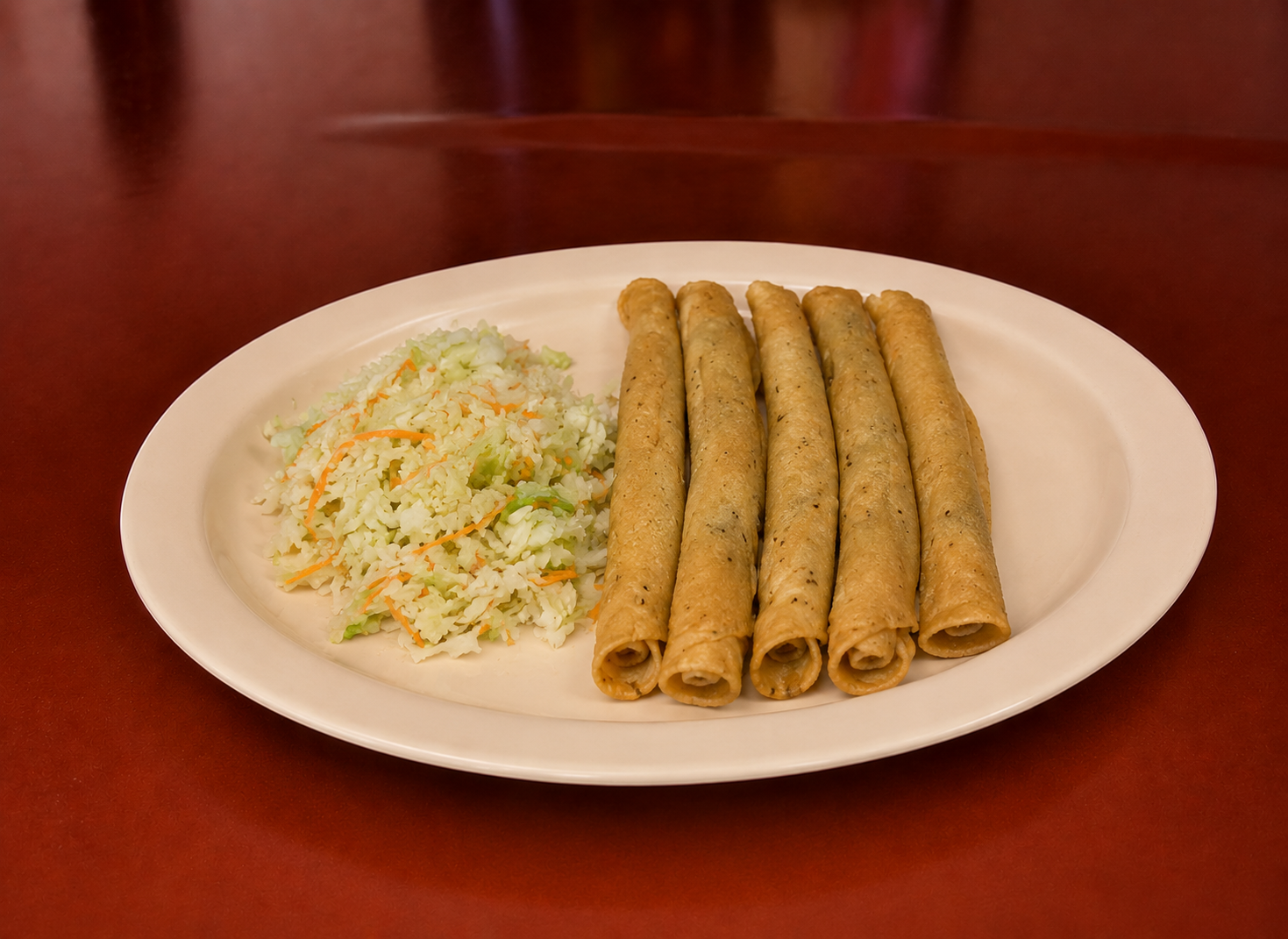 Five crispy flautas with fresh cabbage slaw