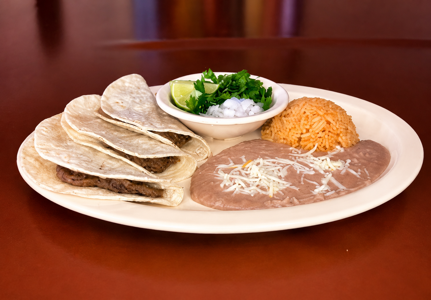 Barbacoa taco plate with rice, beans, lime, cilantro and onion