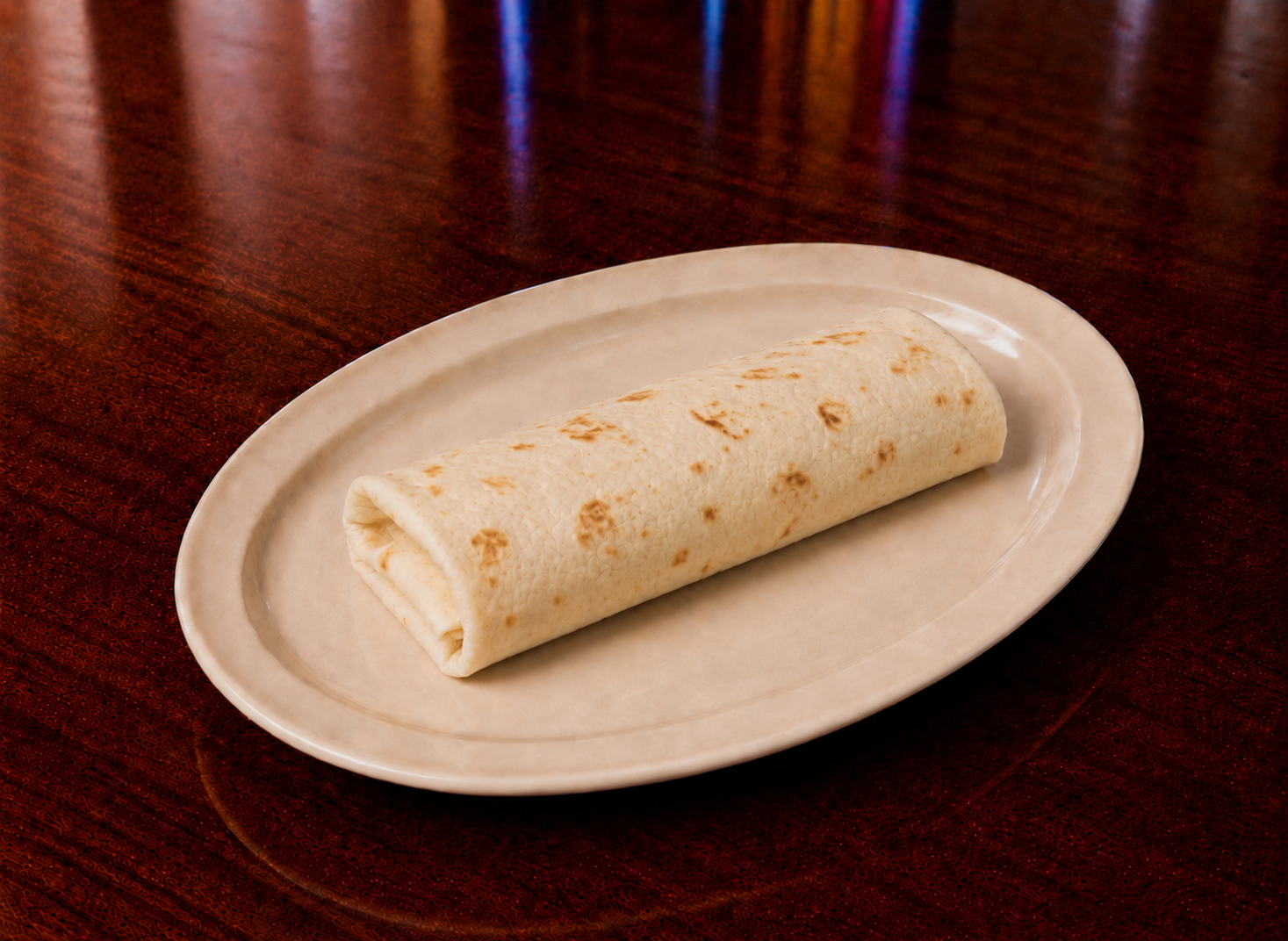 Warm flour burrito on an oval plate