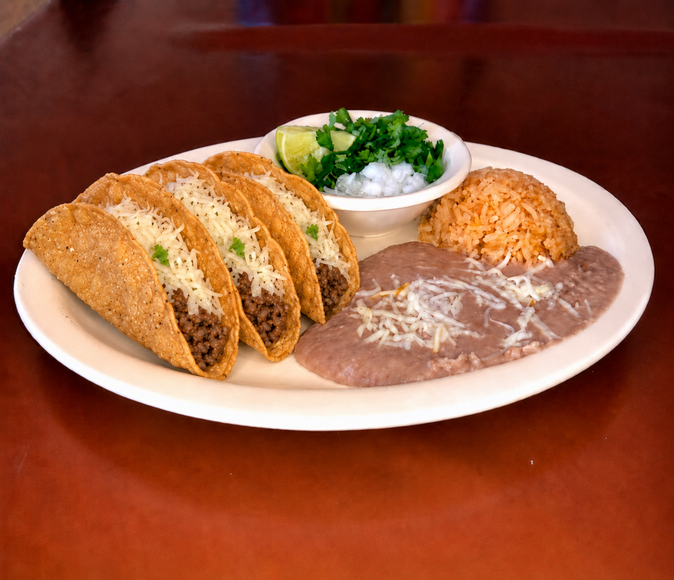 Tacos dorados de deshebrada plate with rice and refried beans