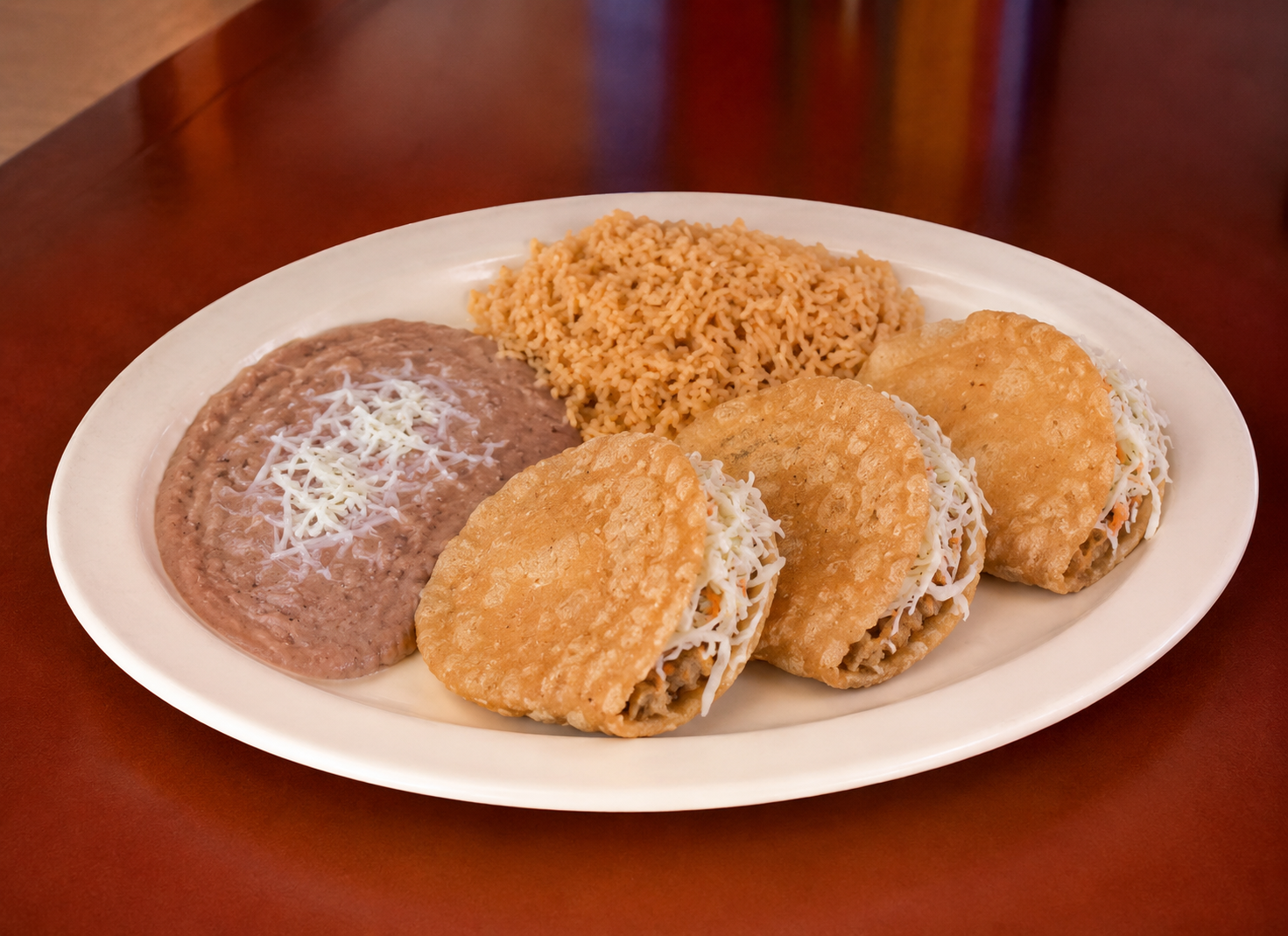 Plate of gorditas with rice and beans