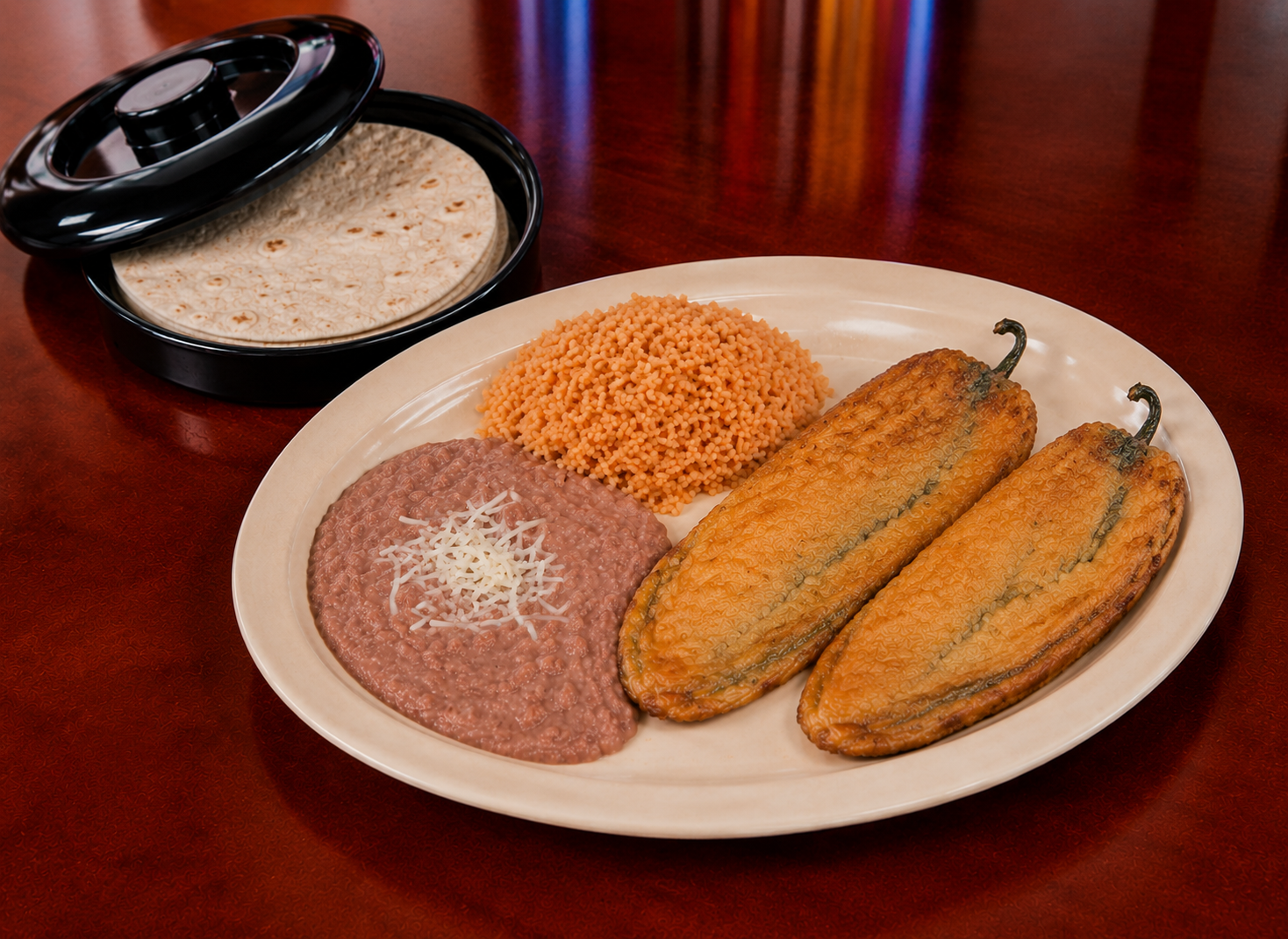 Chile relleno plate with rice, beans and tortillas